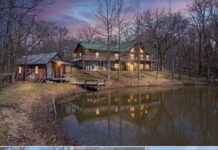 Private Lakefront Log Cabin Retreat on 12 Acres with Wrap-Around Deck Offering Peaceful Living and Scenic Waterfront Views